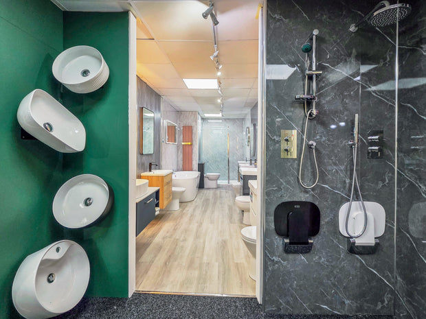 Bathroom interior with green wall, white sinks, and shower area.